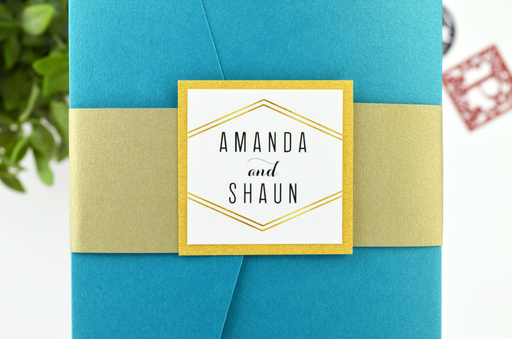 Peacock-Teal-Signature-Pocket-Wedding-Invitation-Gold-Leaf-Belly-Band-Gold-Monogram-Mat-Printed-Monogram-Close-Up